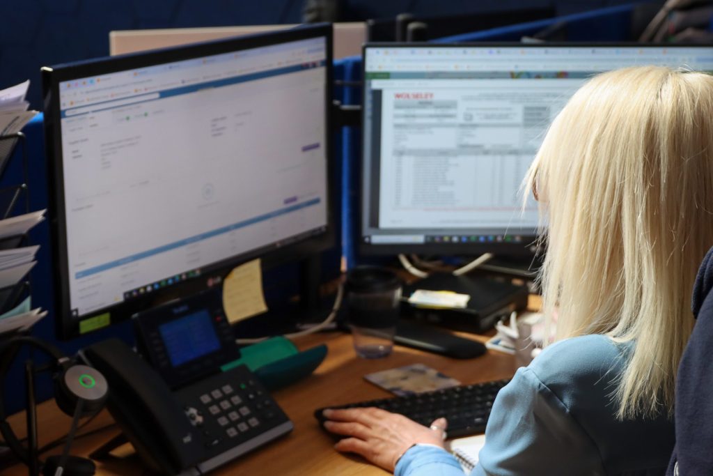 An employee using Commusoft at their desk
