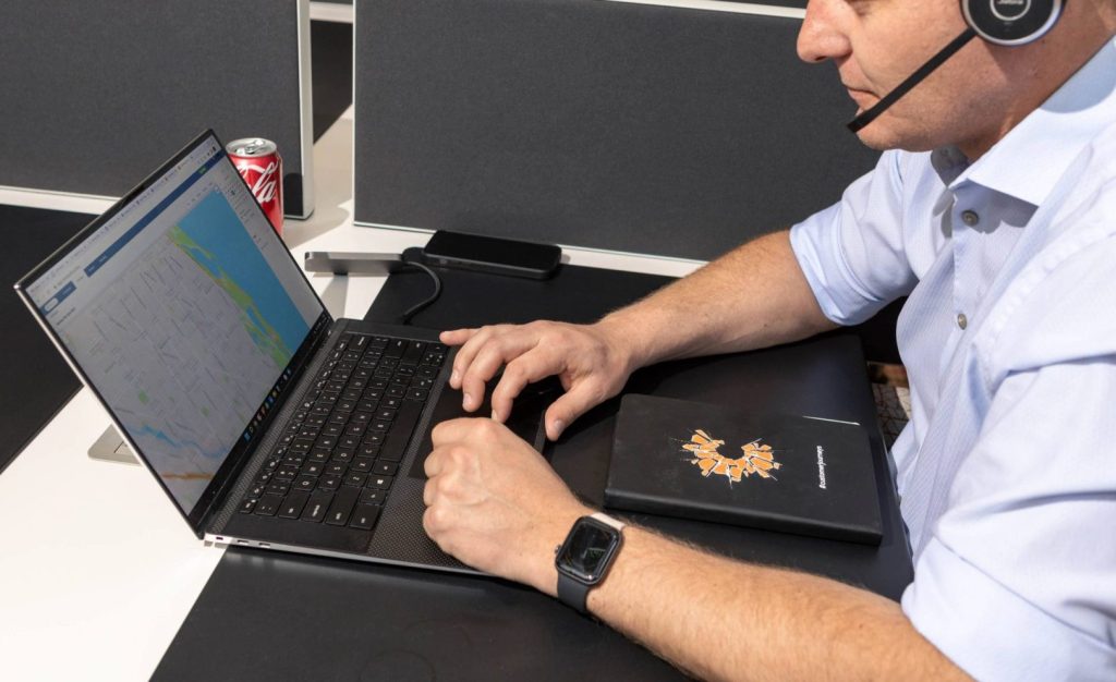 Employee using Commusoft's real-time tracking feature on desktop