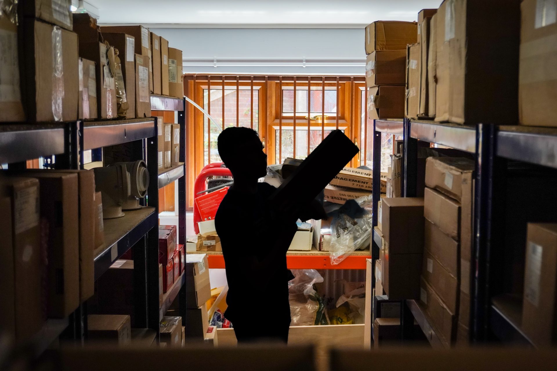Person inspecting inventory in a warehouse
