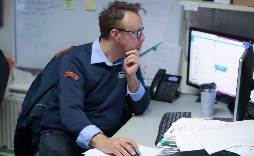 C. Anderson & Sons employee working at their computer