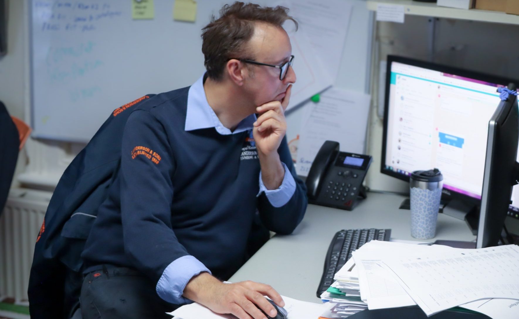 C. Anderson & Sons employee working at their computer