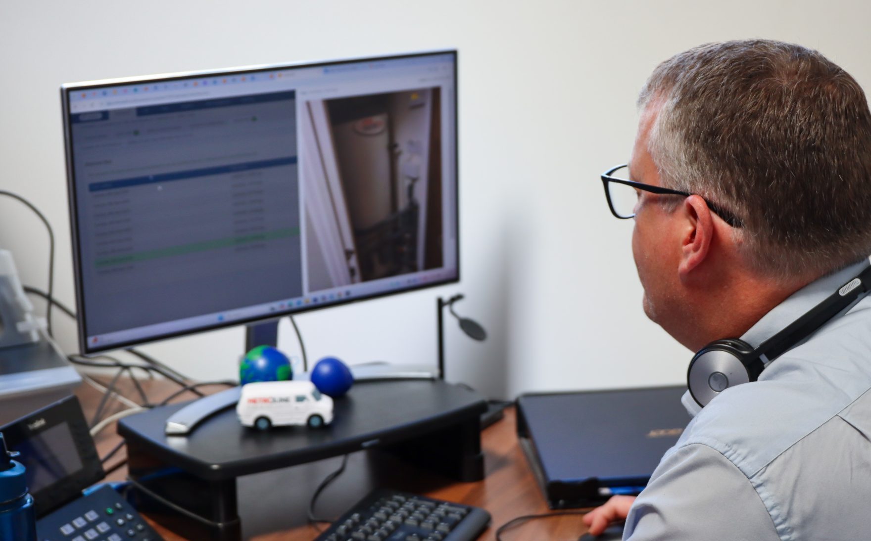 Employee working at their desk using Commusoft