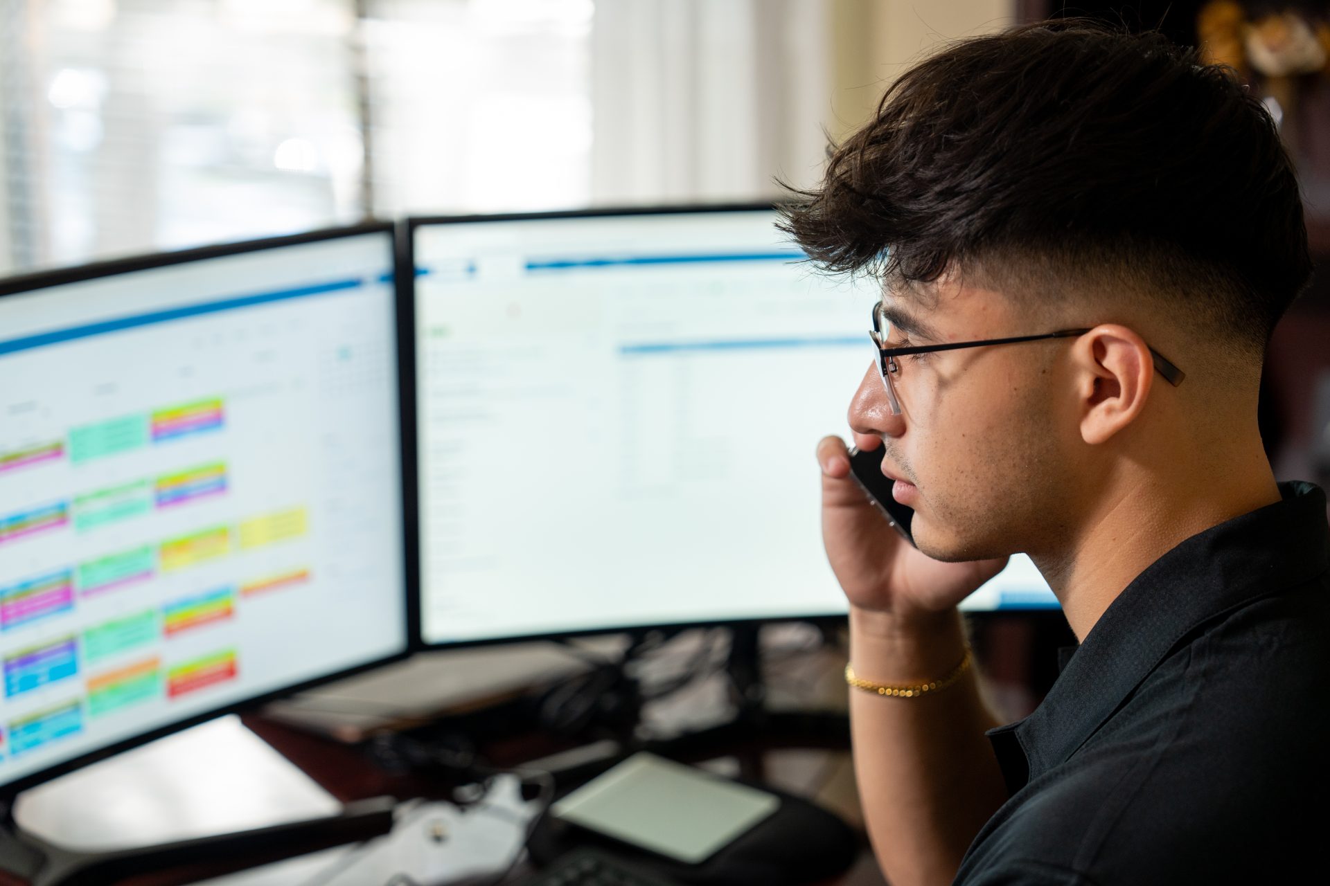 An employee on the phone and using Commusoft's job scheduling feature