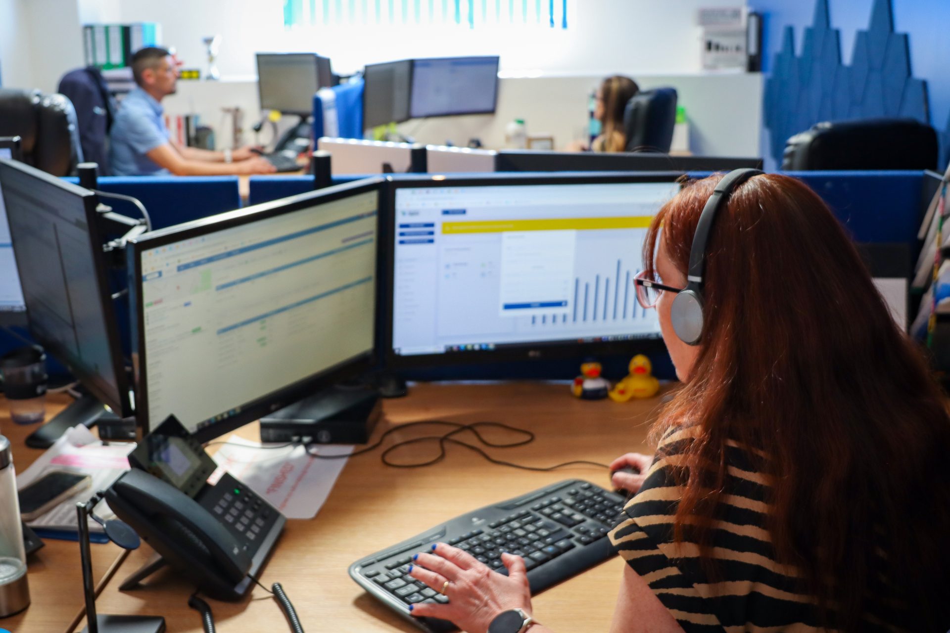 Employee with a headset working at their desk