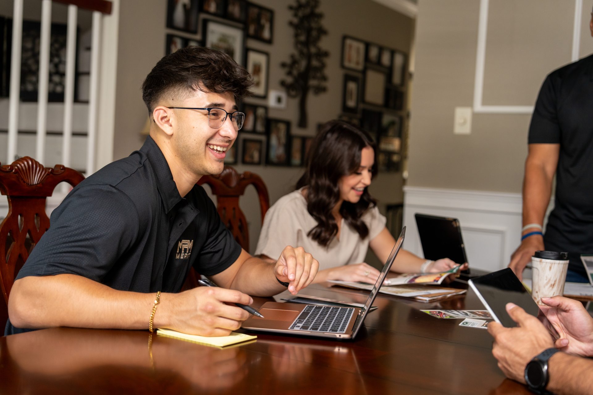 Merit Facility Management team members sat at a table working and laughing