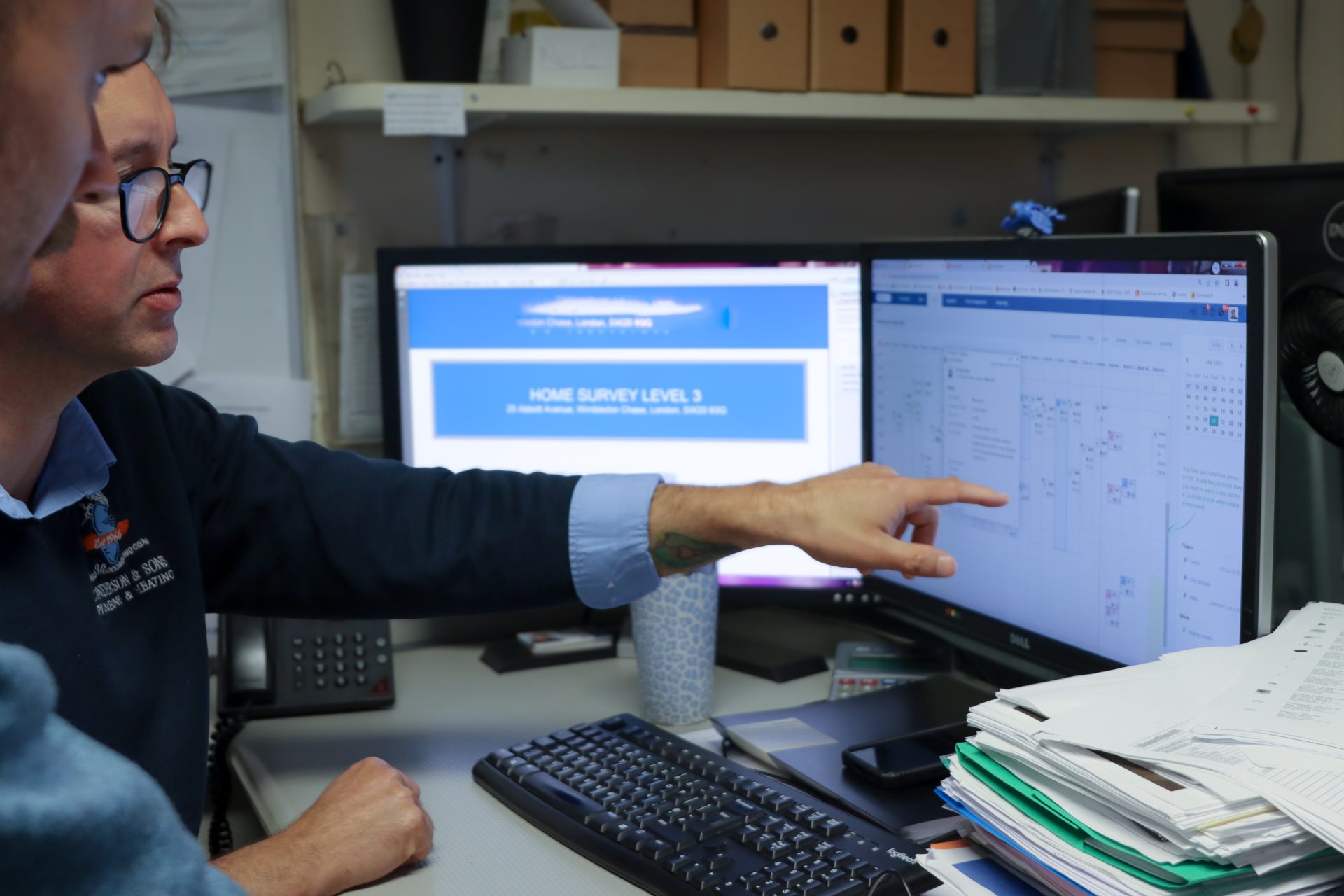 C. Anderson & Sons employee pointing at a job in Commusoft's scheduling feature