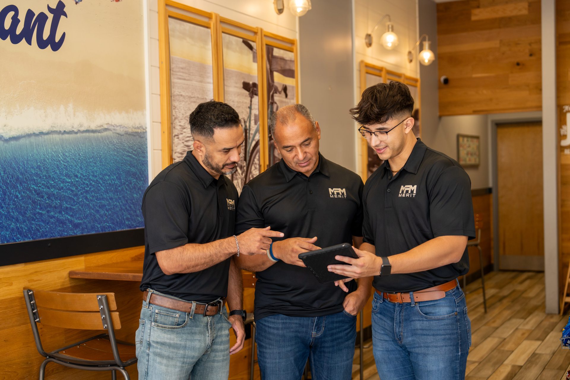 Merit Facility Management team members looking at a tablet