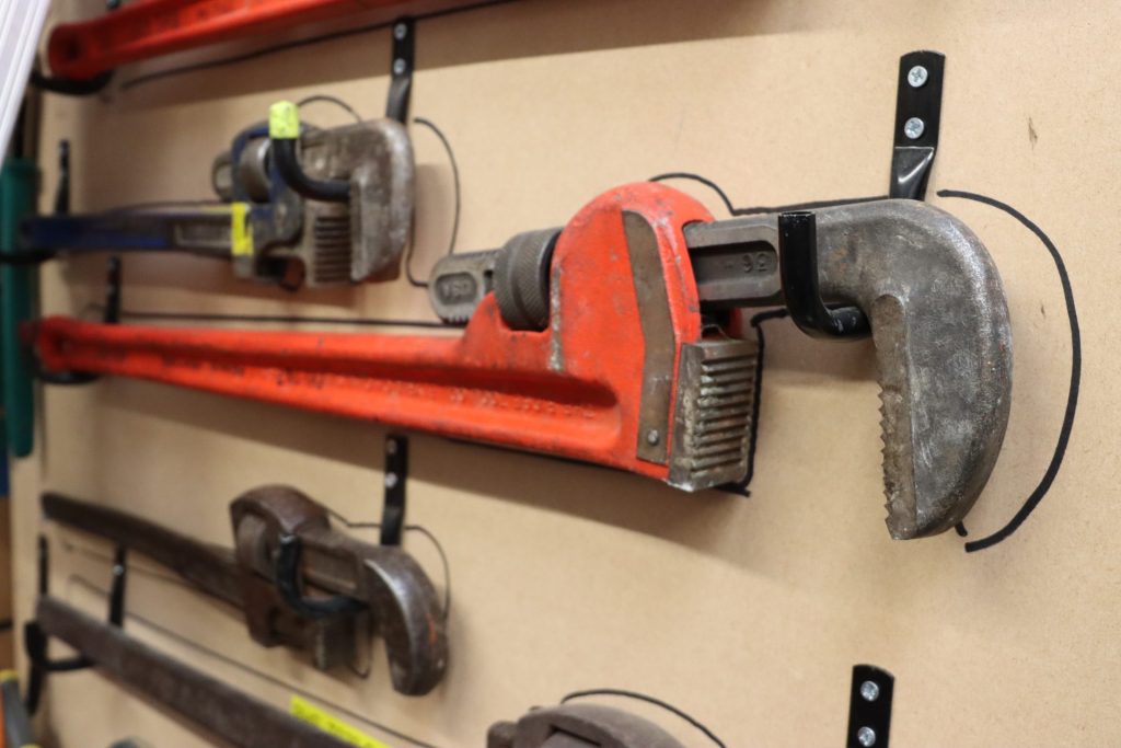 Plumbing tools fixed to a wall