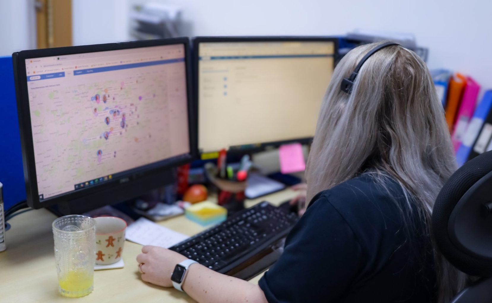 Employee sat at their desk using Commusoft's real-time tracking feature