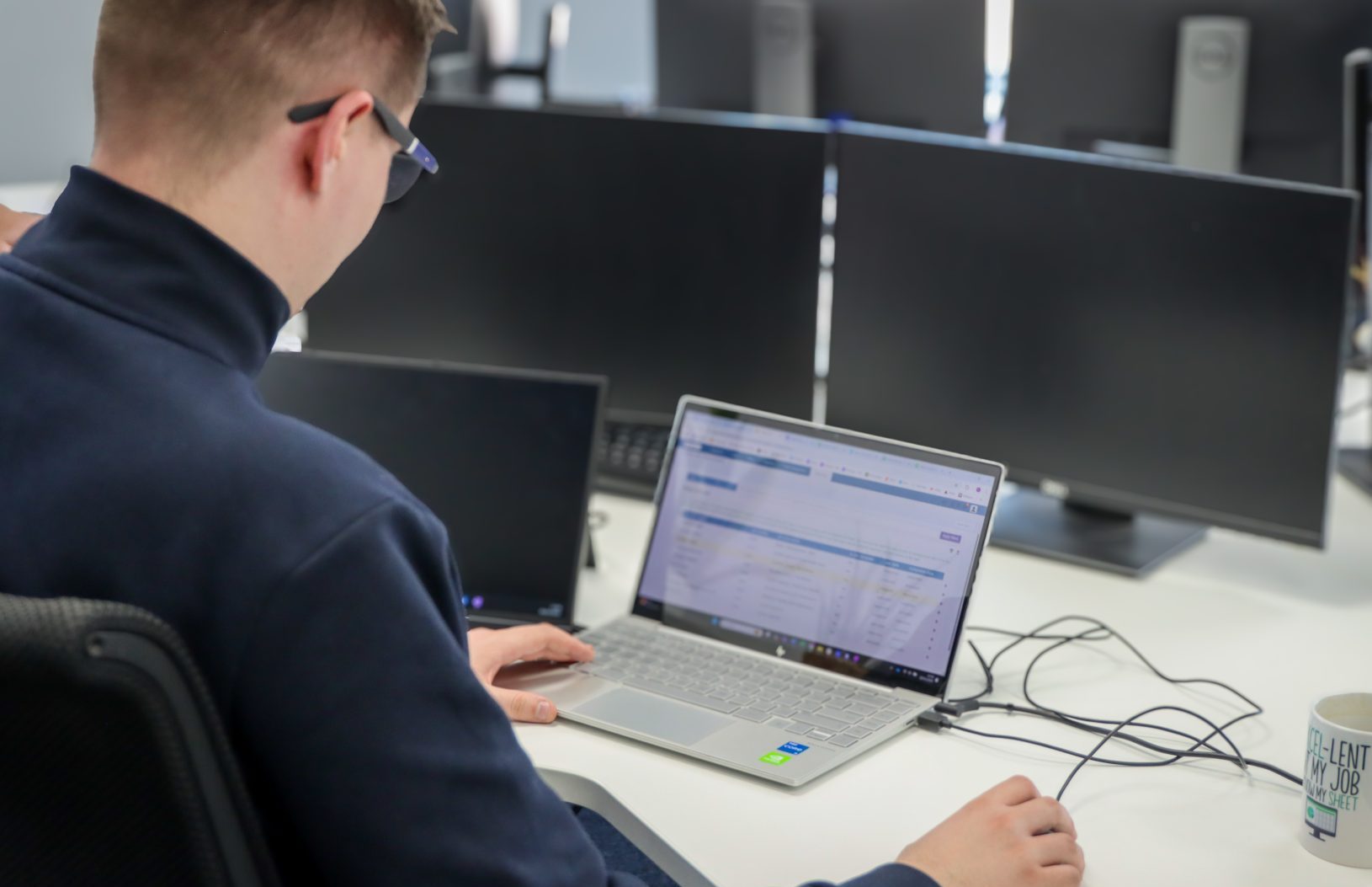 Employee working at their desk using Commusoft system