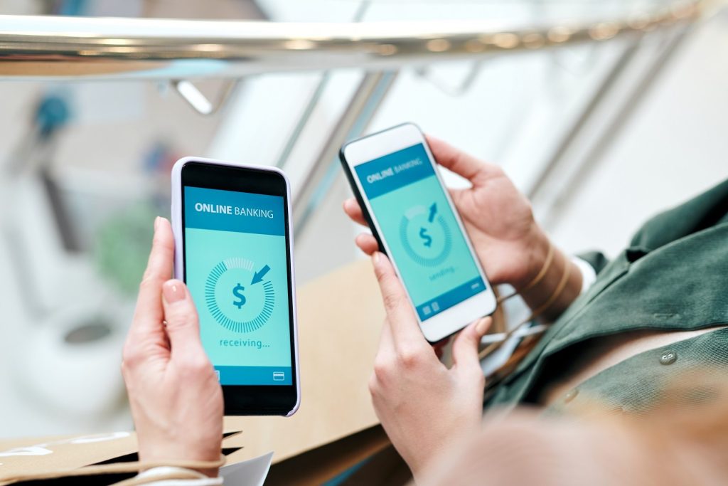 Two people holding phones to make instant payments