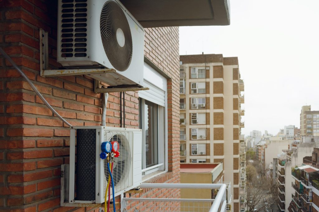 HVAC system fixed to the exterior of an apartment building in a city