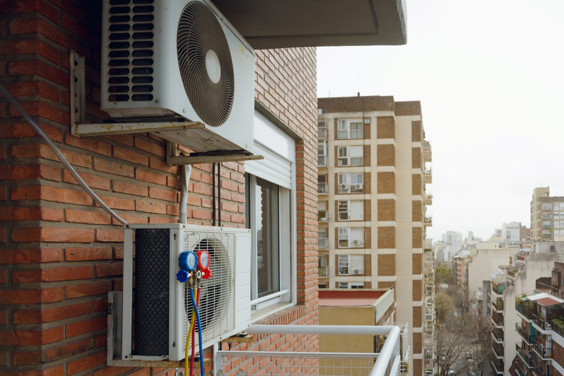 HVAC system fixed to the exterior of an apartment building in a city