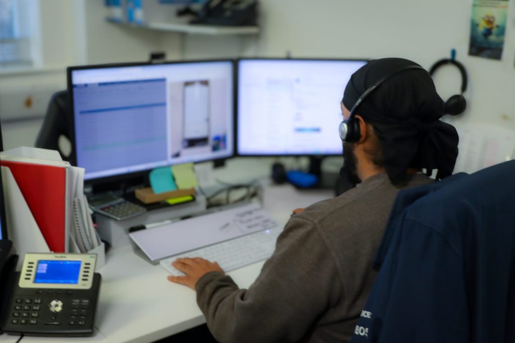 Employee working on Commusoft at their desk