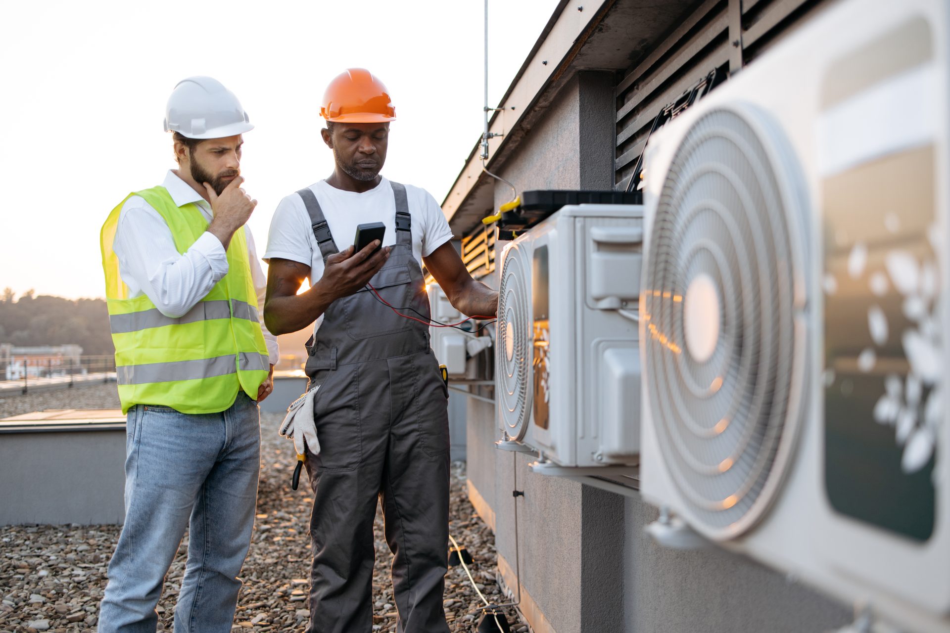 Two engineers carrying out an inspection on a rooftop
