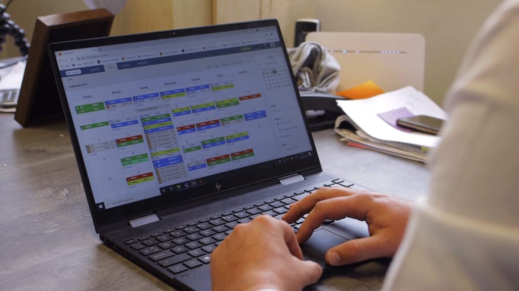 Employee using Commusoft on their laptop at a desk