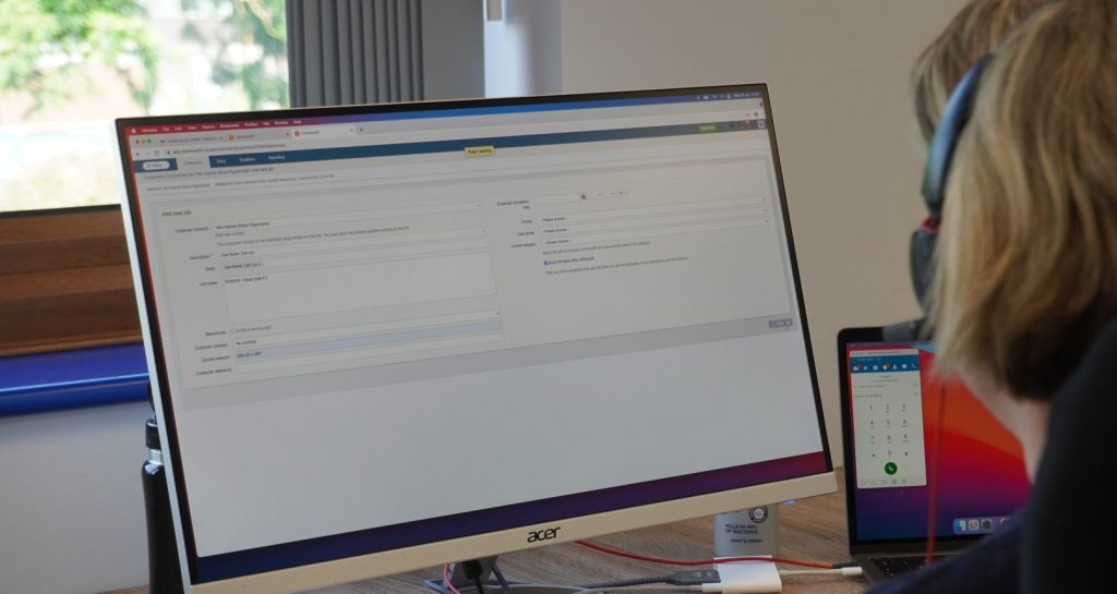 Wiorker looking at Commusoft on their dekstop