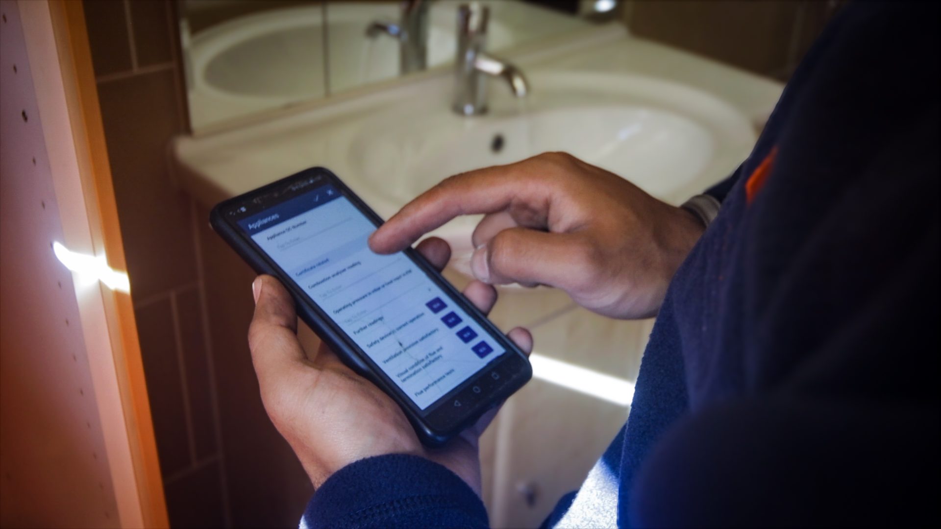 Engineer using the Commusoft app on their mobile