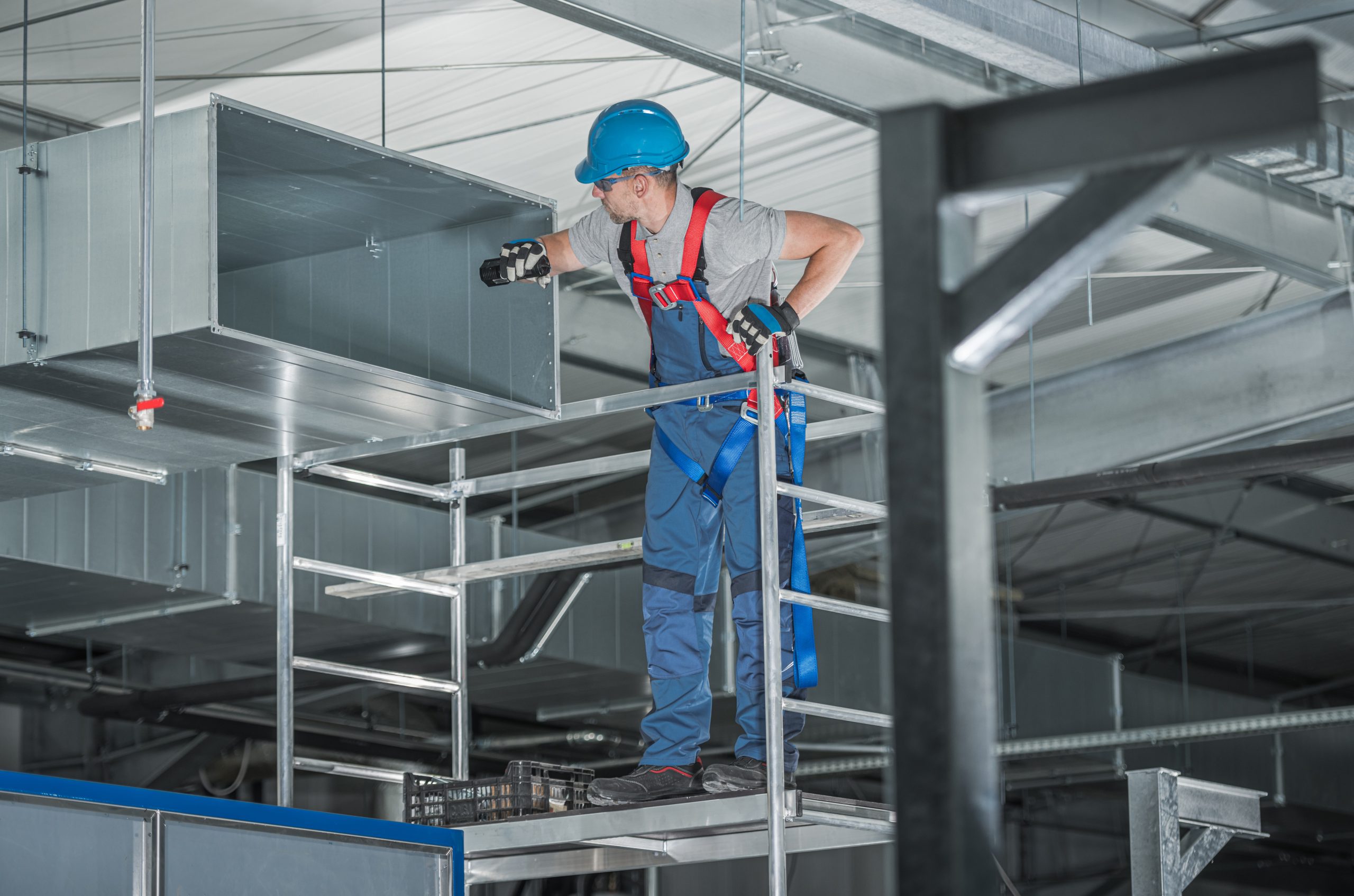 HVAC worker looking inside an air duct
