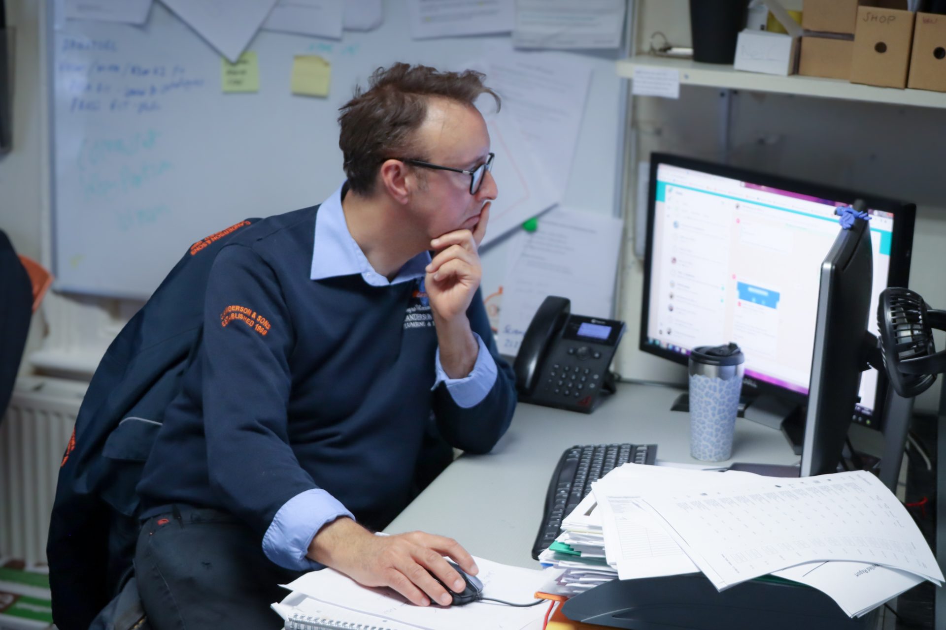 C. Anderson and Sons team member working at computer