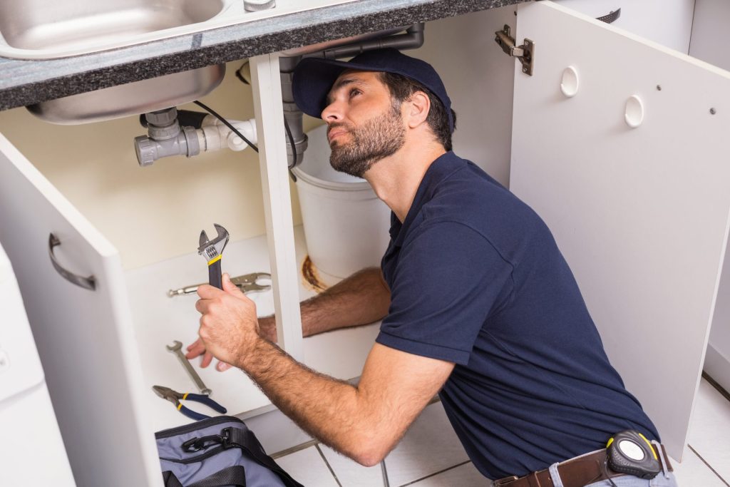 Plumber working on kitchen sink
