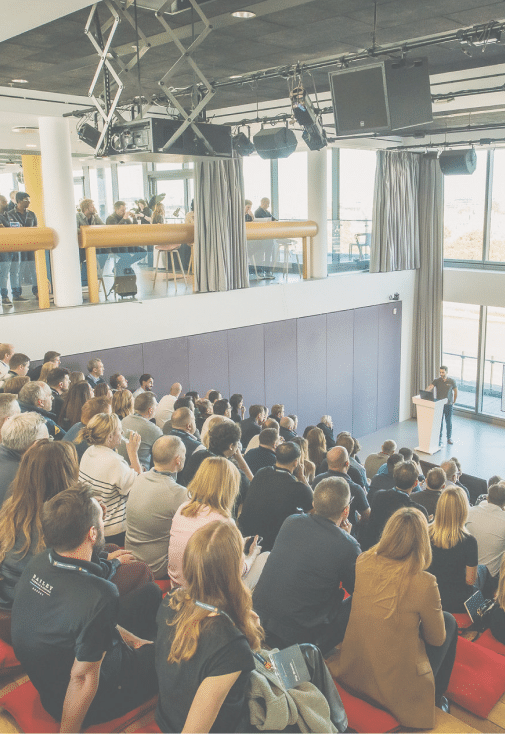 Audience listening to Jason Morjaria's speech at Connect & Preview event September 2025