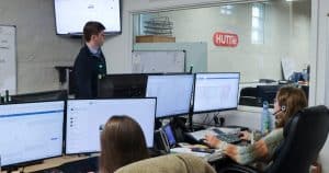 Huttie Building Services team collaborating in the office