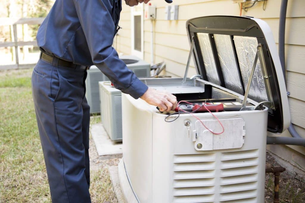 Engineer working on a generator repair outside