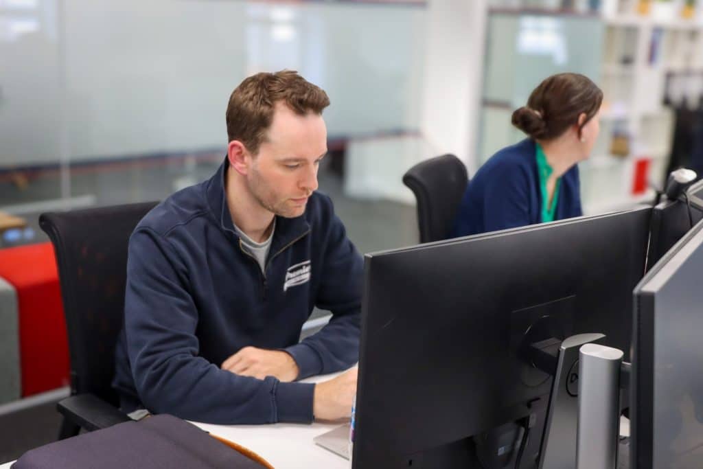 Premier Heating Solutions owner working at a desk in the office
